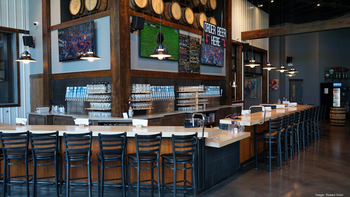 Bar with wooden barrels and beer taps.